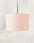 Blush pink lampshade hanging from ceiling