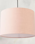 Blush pink pendant lampshade hanging from ceiling